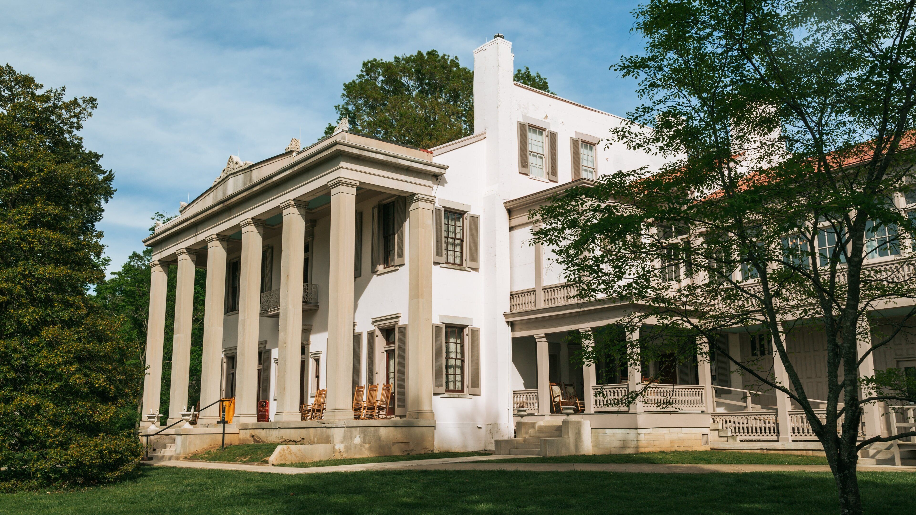 A classical building with columns and a balcony.
