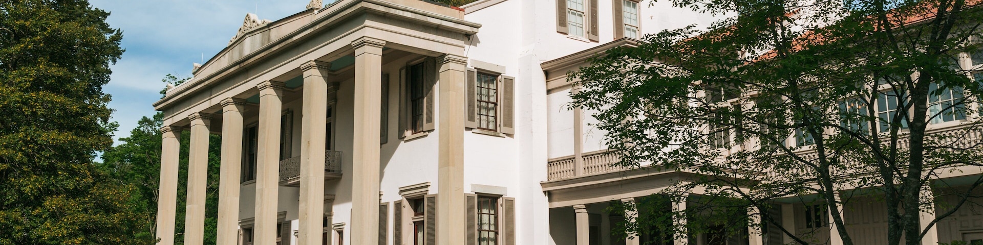A classical building with columns and a balcony.
