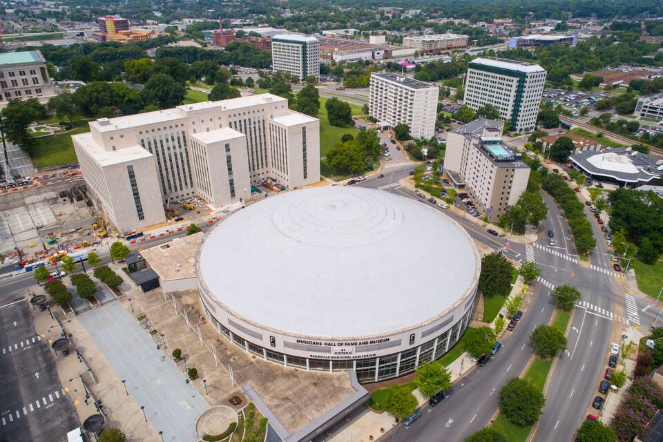 A large circular building with a dome, surrounded by roads and other buildings.