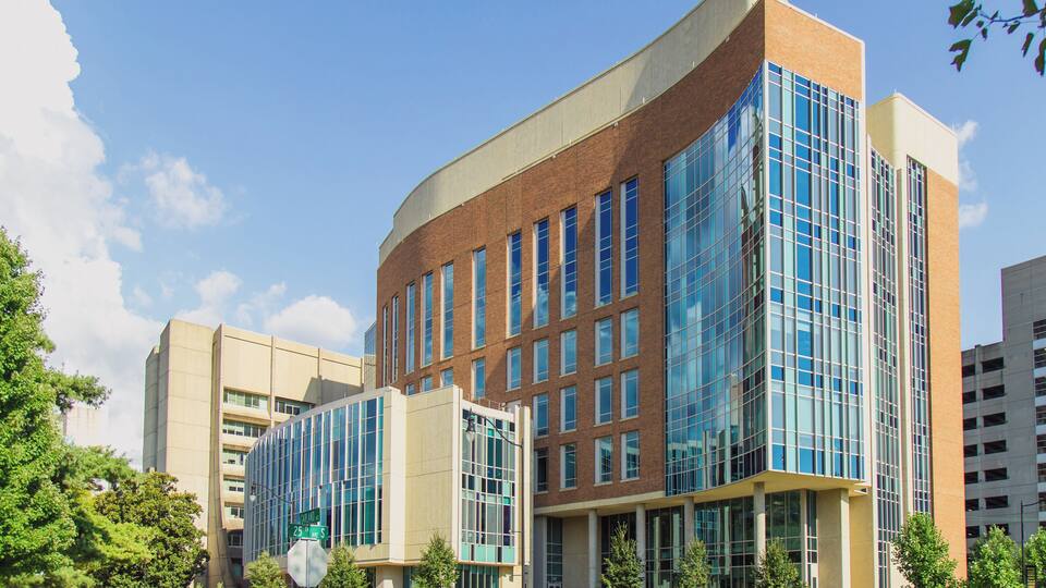 A modern building with large glass windows and a brick facade.