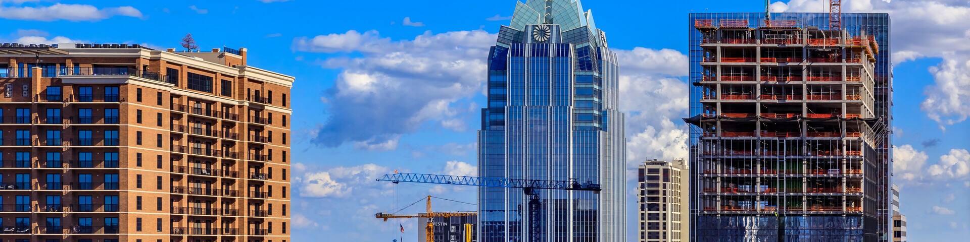 Modern office buildings of tech firms downtown with the famous Frost Bank Tower in the background in Austin, Texas, USA