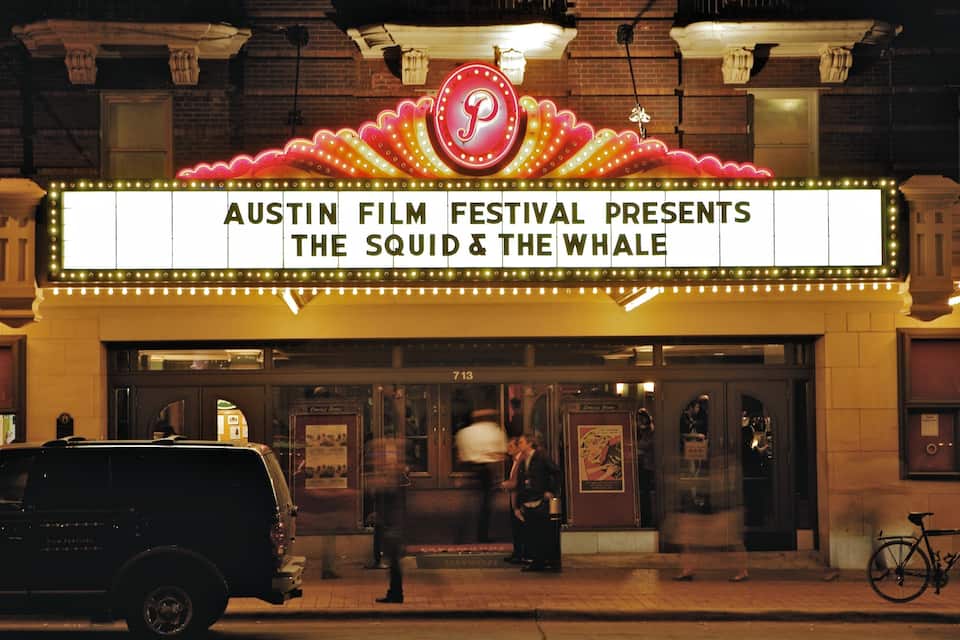 A theater marquee advertising the Austin Film Festival's presentation of 'The Squid & The Whale'.
