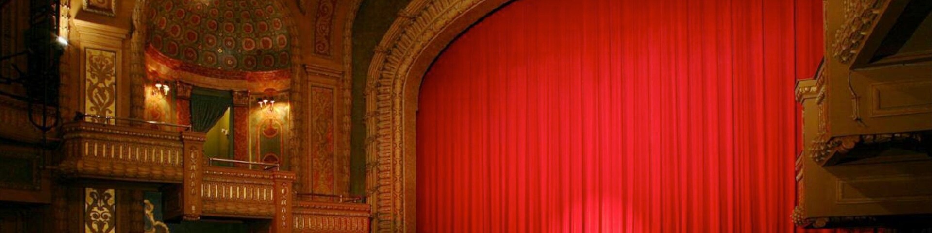 Historic performance space at Paramount Theatre in Austin, Texas features grand red curtain and ornate architecture
