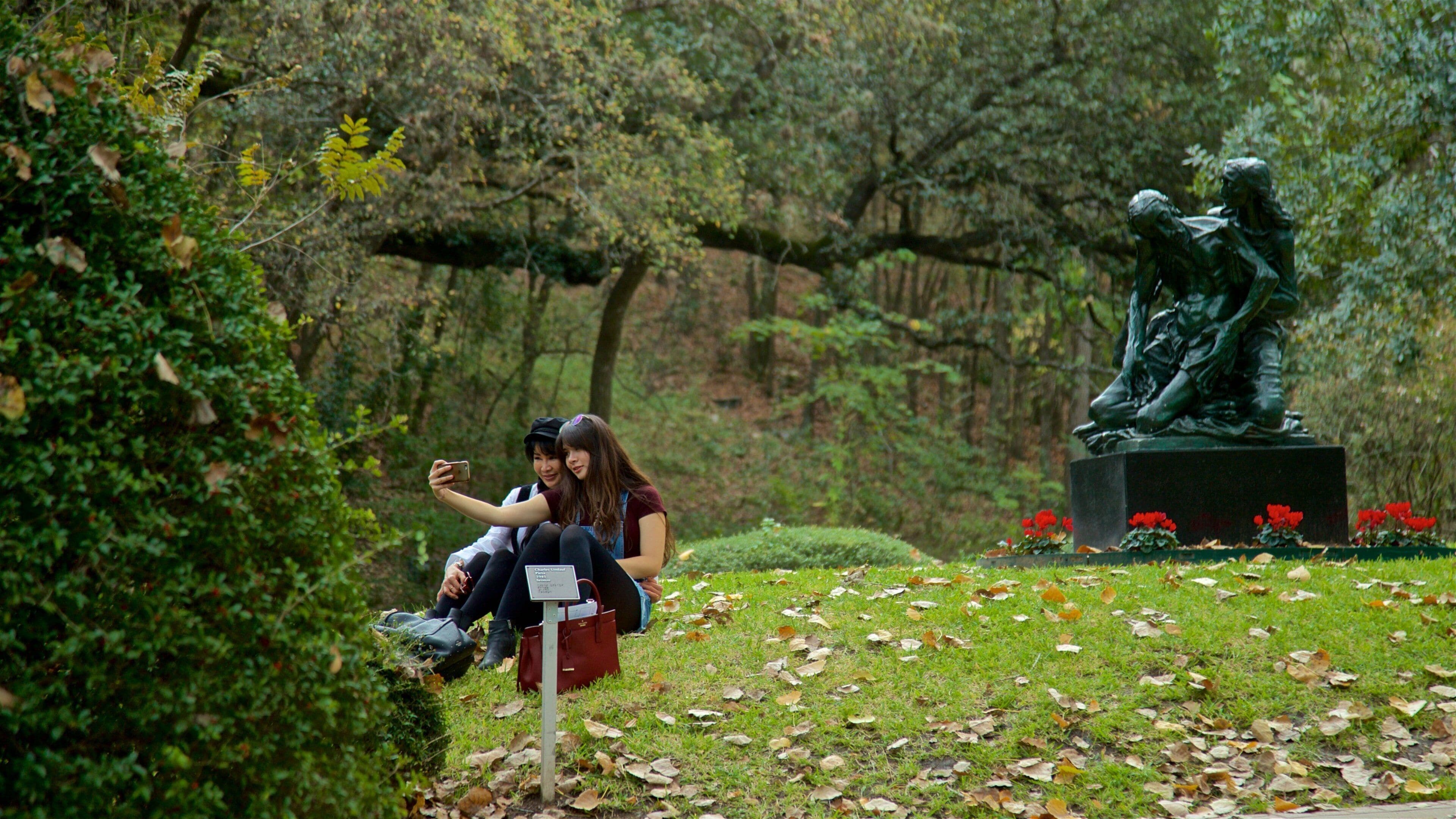 Umlauf Sculpture Garden and Museum showing a statue or sculpture and a garden as well as a couple