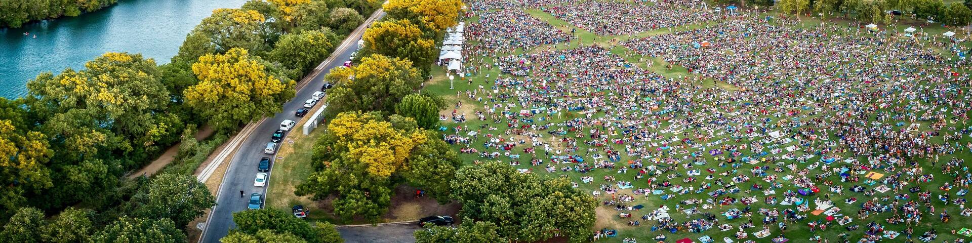 A river, a large crowd, and a city skyline.