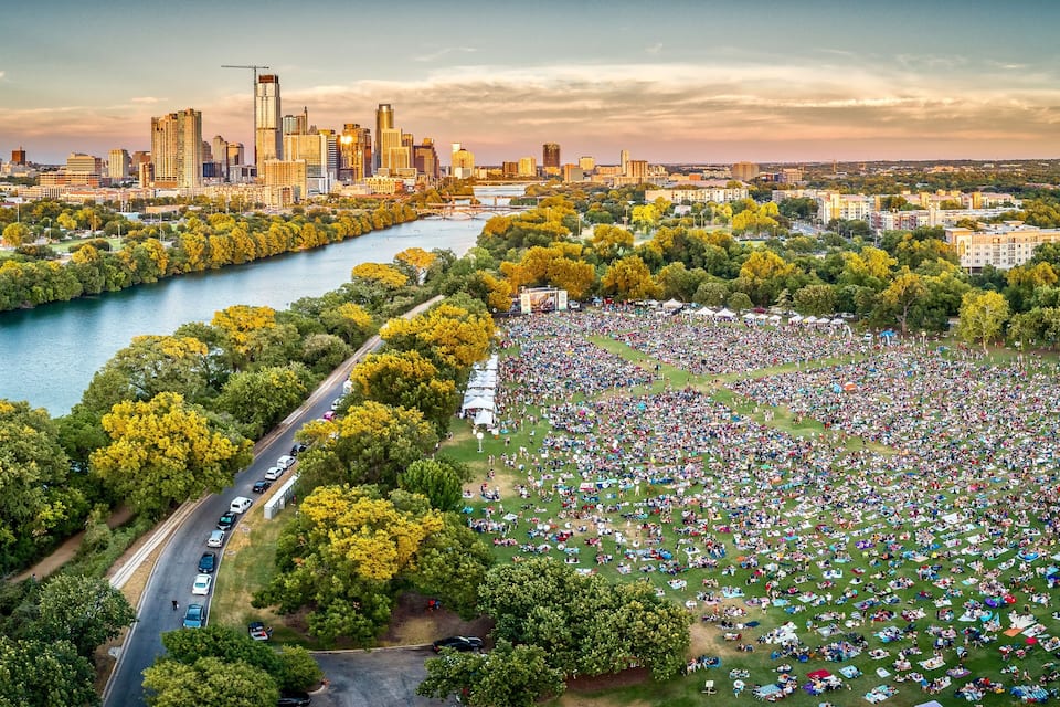 A river, a large crowd, and a city skyline.