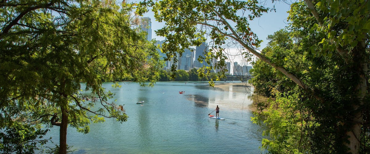 Zilker Park showing a bay or harbor and kayaking or canoeing