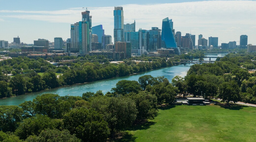 Zilker Park which includes landscape views, a city and a river or creek