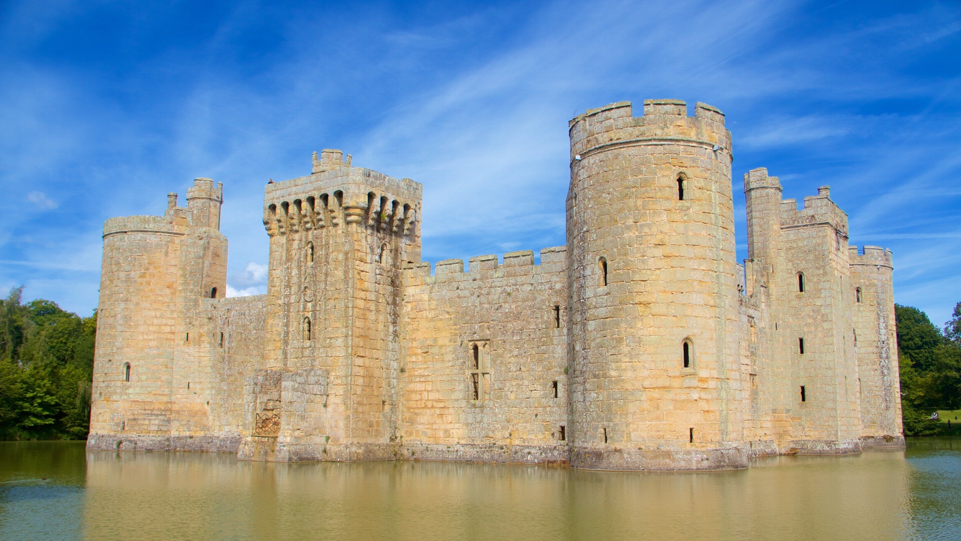 A large medieval castle with multiple towers and a moat surrounding it.