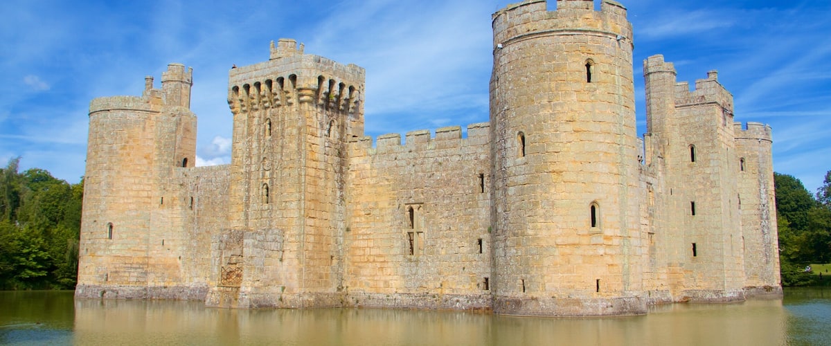 A large medieval castle with multiple towers and a moat surrounding it.