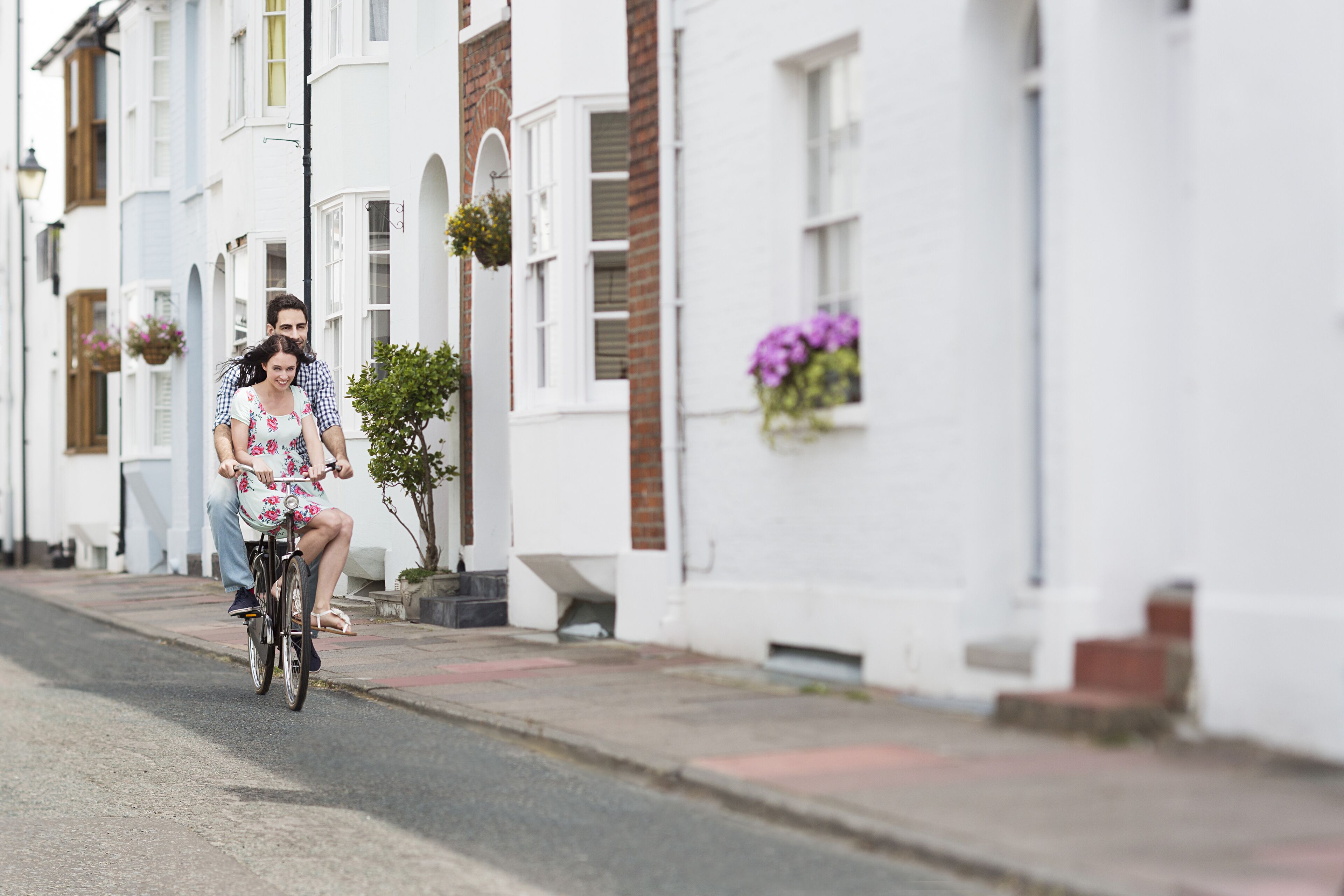 A man and a woman riding a bicycle