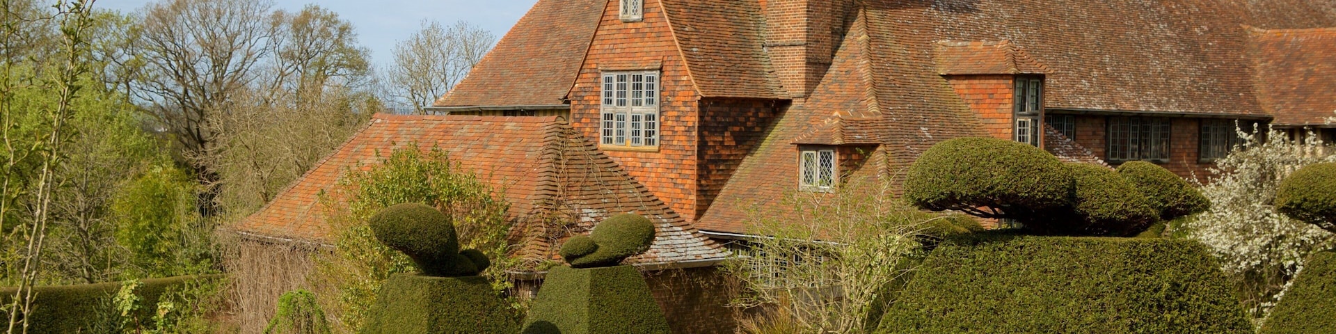 Great Dixter House and Gardens featuring flowers, heritage elements and a park