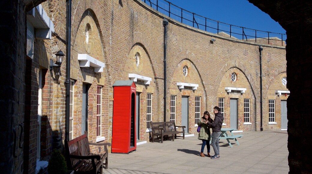 Redoubt Fortress and Military Museum showing heritage elements as well as a small group of people