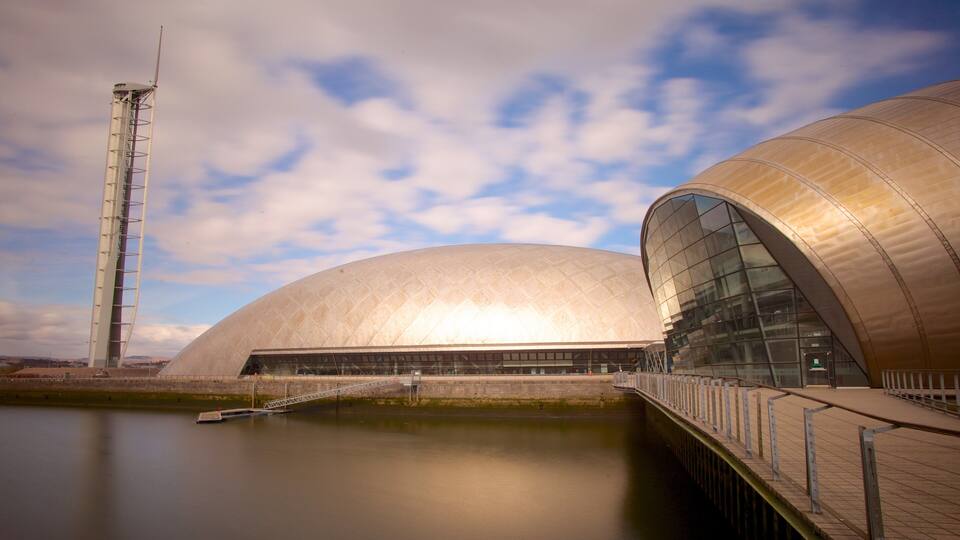 A modern architectural structure with a large dome and a tall tower.