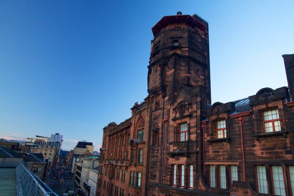A historic building with a prominent tower and arched windows.