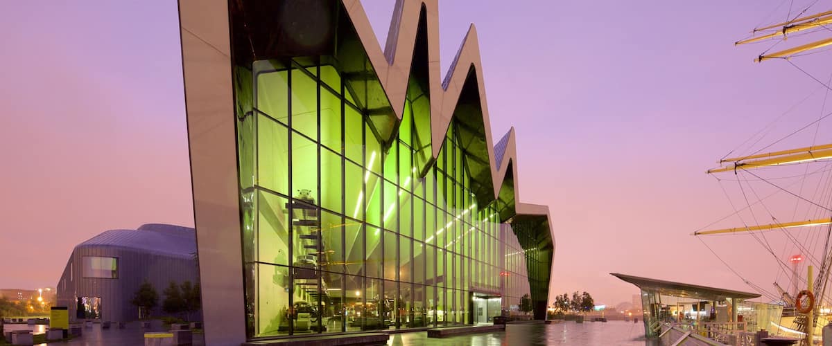 Riverside Museum featuring modern architecture, a sunset and mist or fog