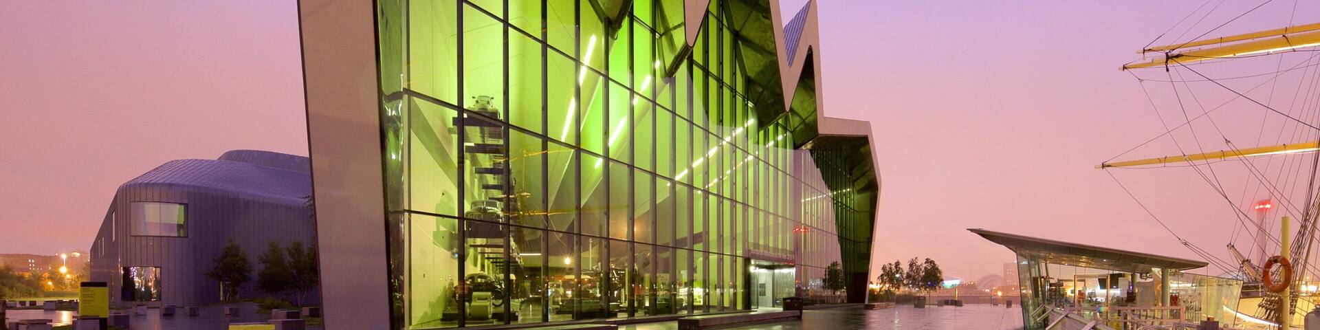 Riverside Museum featuring modern architecture, a sunset and mist or fog