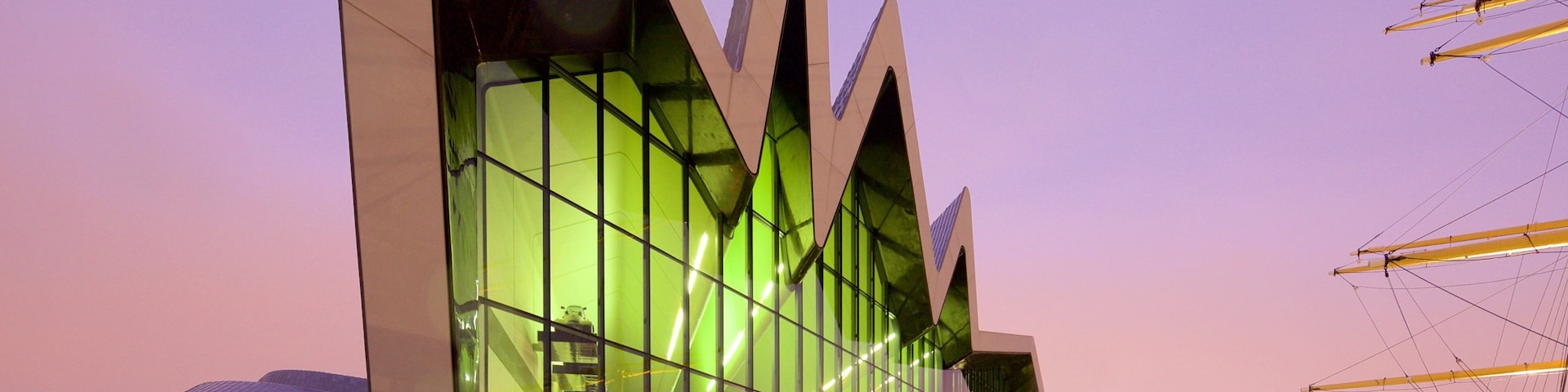 Riverside Museum featuring modern architecture, a sunset and mist or fog