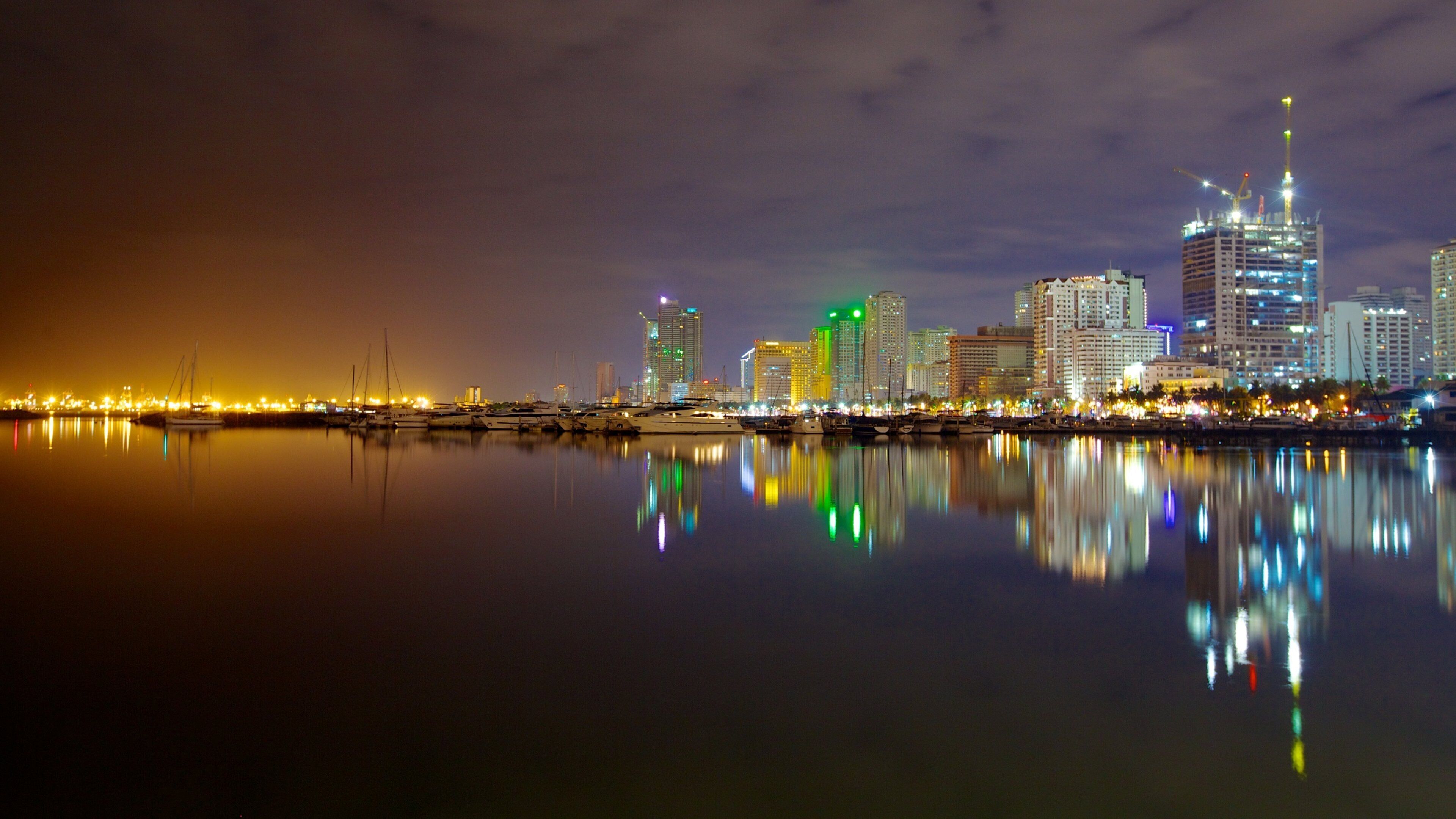 Baywalk featuring a bay or harbor, a high rise building and a city
