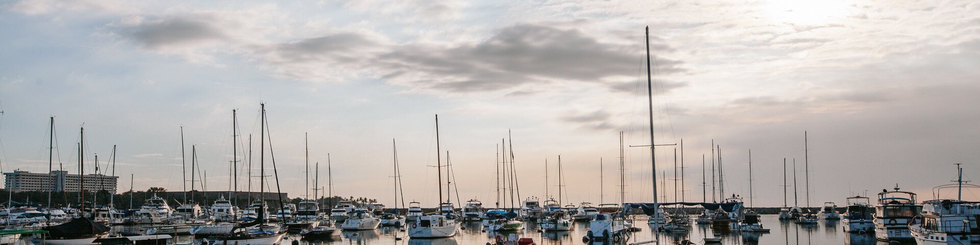 Baywalk featuring a bay or harbor and a sunset