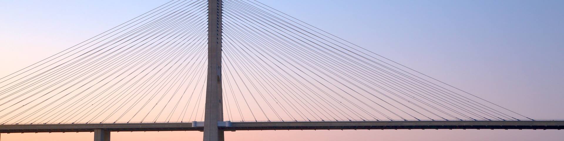 Vasco da Gama Bridge showing modern architecture, a bridge and a sunset