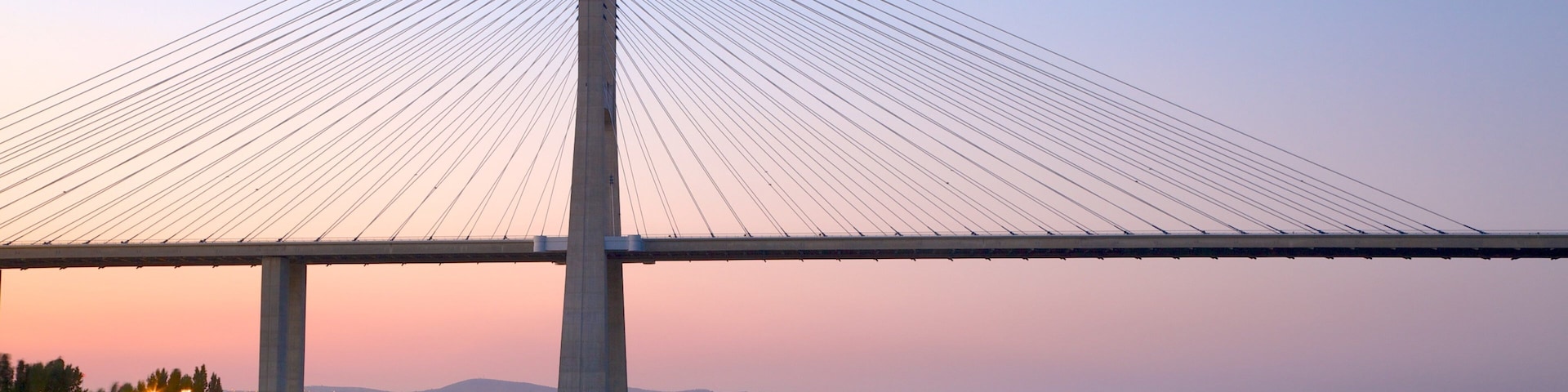 Vasco da Gama Bridge showing modern architecture, a bridge and a sunset