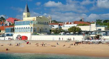 Tamariz Beach showing general coastal views and a beach as well as a small group of people