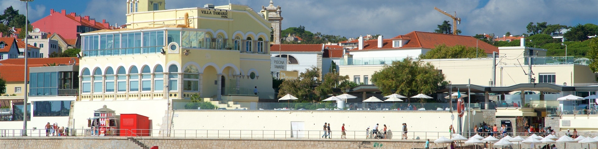 Tamariz Beach showing general coastal views and a beach as well as a small group of people