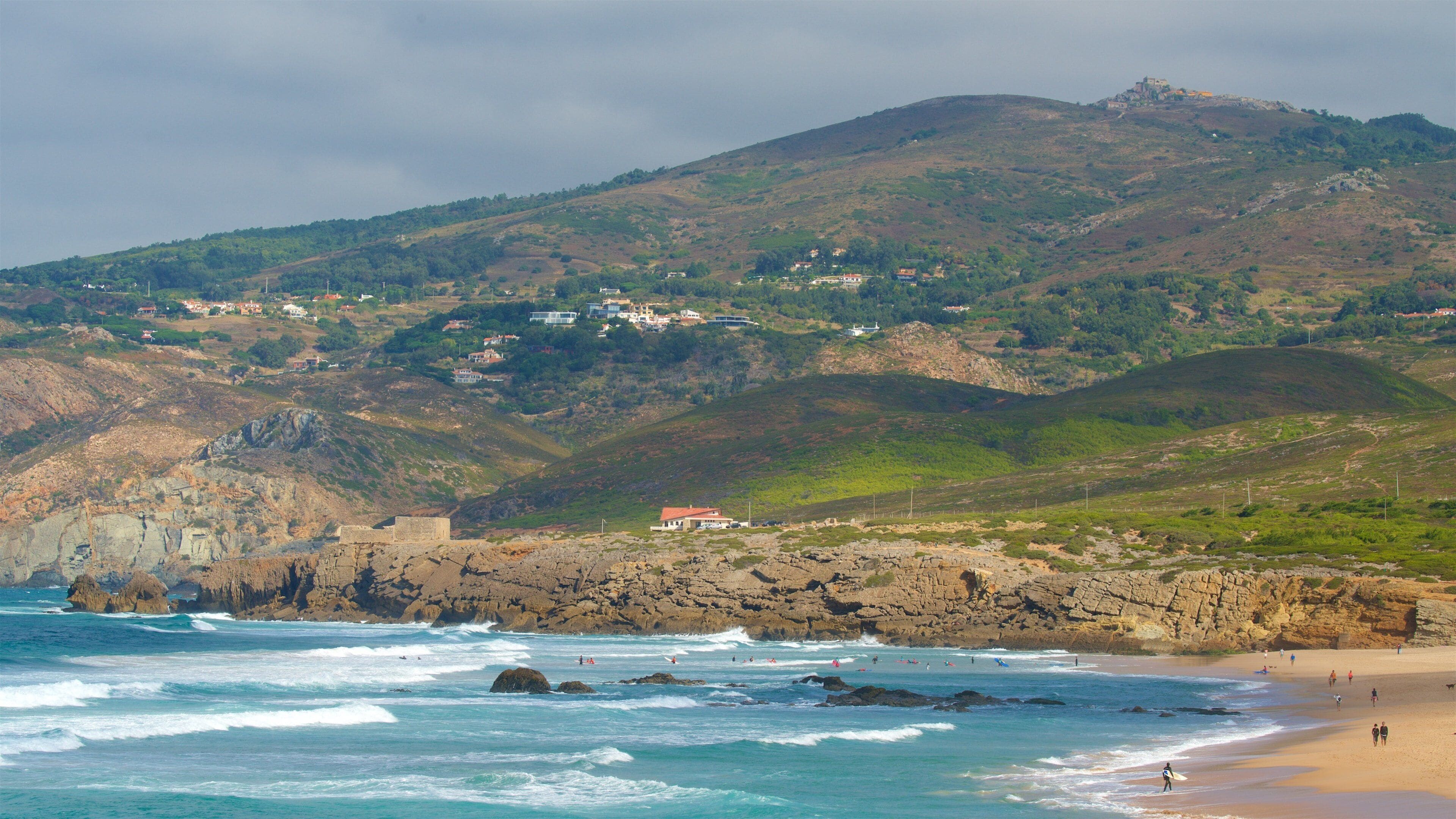Guincho Beach featuring rugged coastline, a beach and tranquil scenes