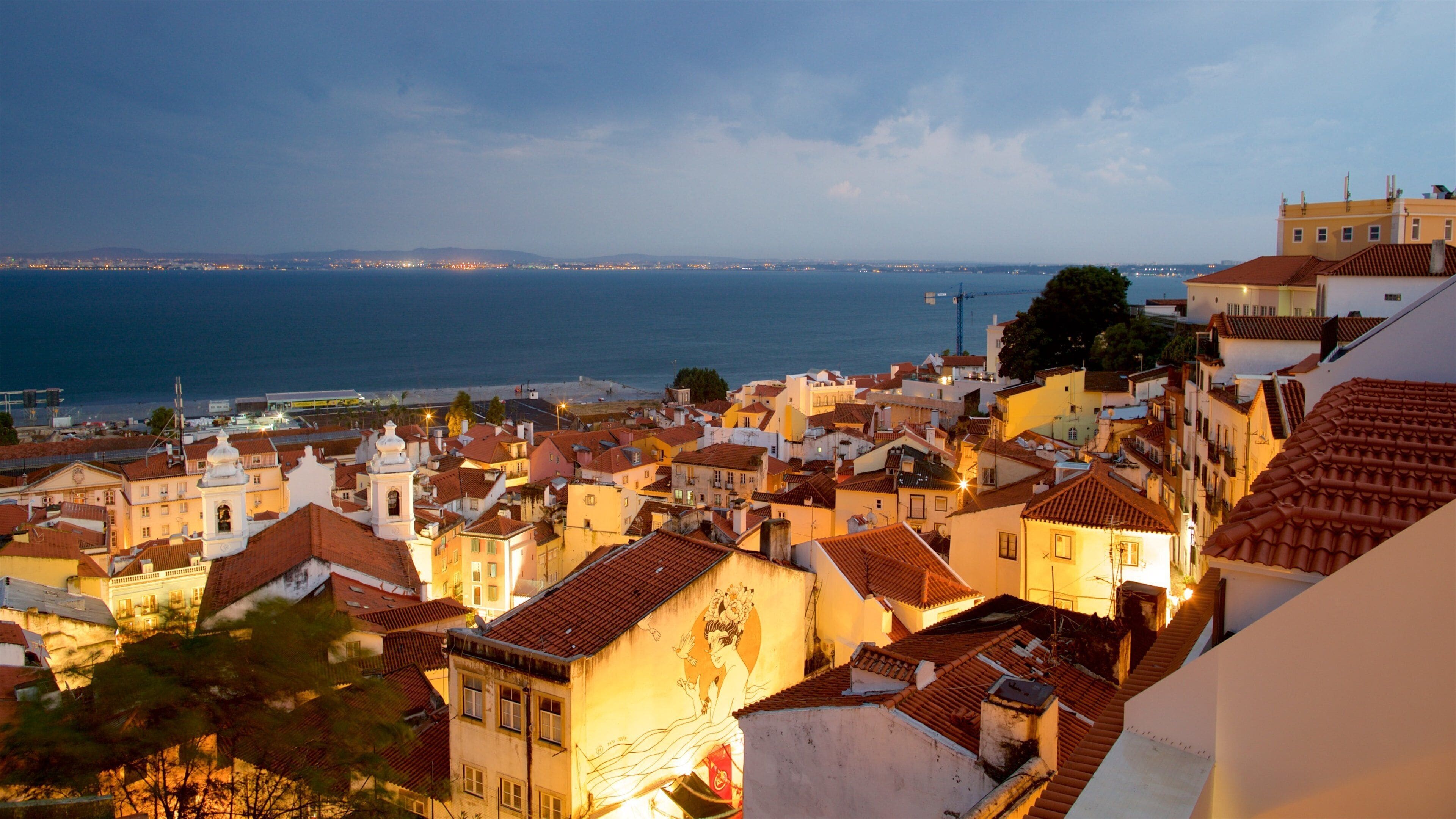 Miradouro de Santa Luzia which includes a coastal town and a lake or waterhole