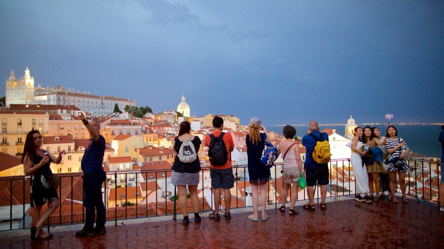 Miradouro de Santa Luzia showing night scenes, a city and views