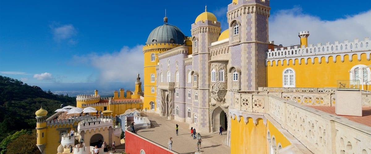 Pena Palace with its distinctive yellow and white facade, domed towers, and ornate balconies.