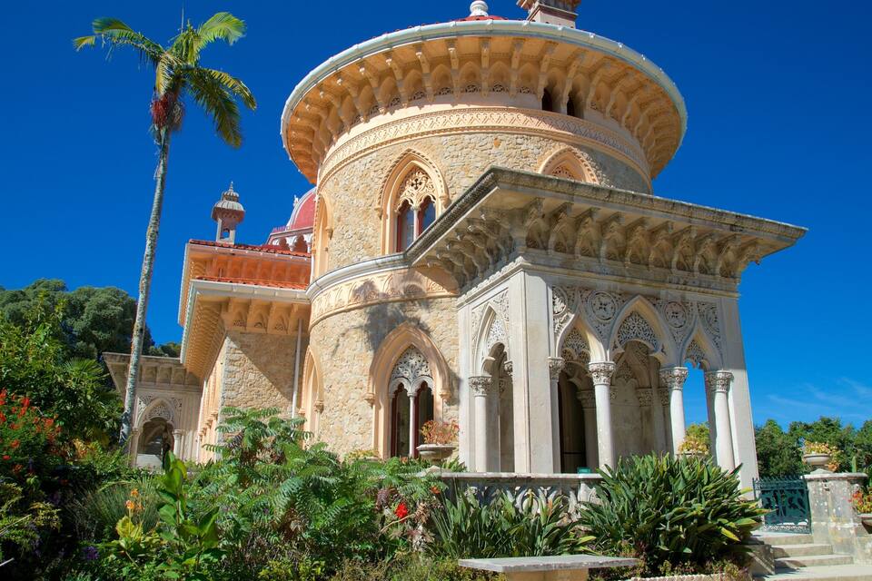 A historic building with ornate stonework, a dome, and a red-tiled roof.