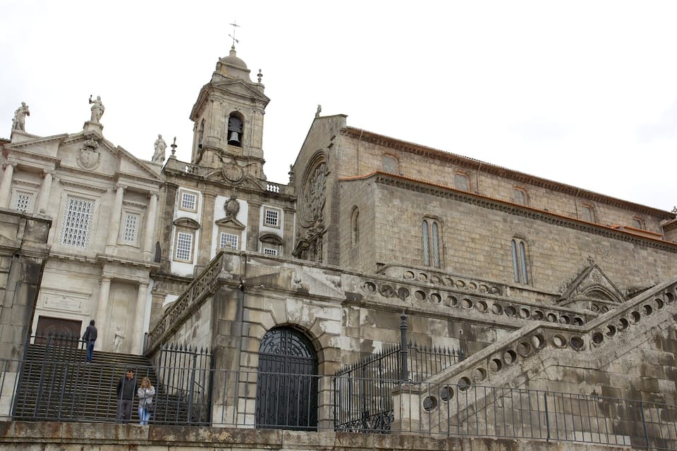 A historic church with ornate architecture, including a bell tower and statues.