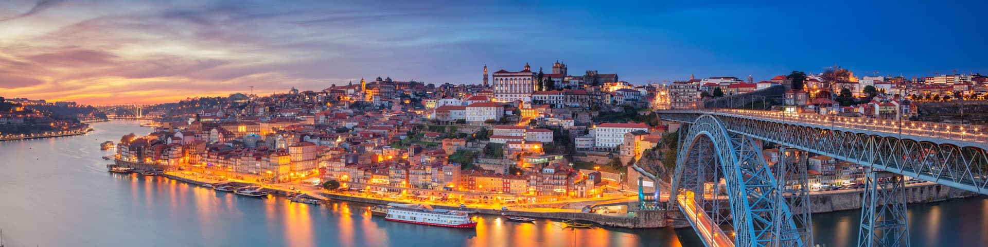 Porto, Portugal. Panoramic cityscape image of Porto, Portugal with the famous Luis I Bridge and the Douro River during dramatic sunset.