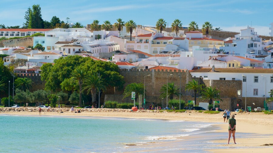 Meia Praia Beach showing a coastal town, a beach and general coastal views