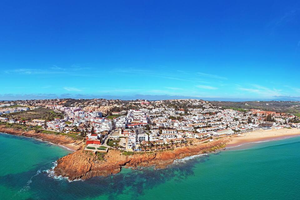 A coastal town with a beach and cliffs.