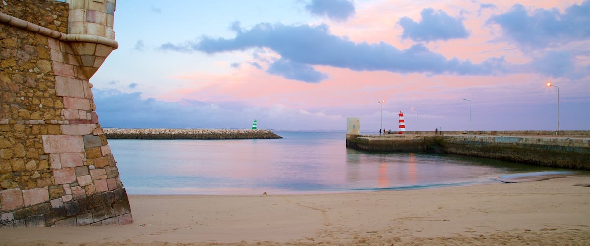 Lagos which includes a sandy beach, a sunset and general coastal views