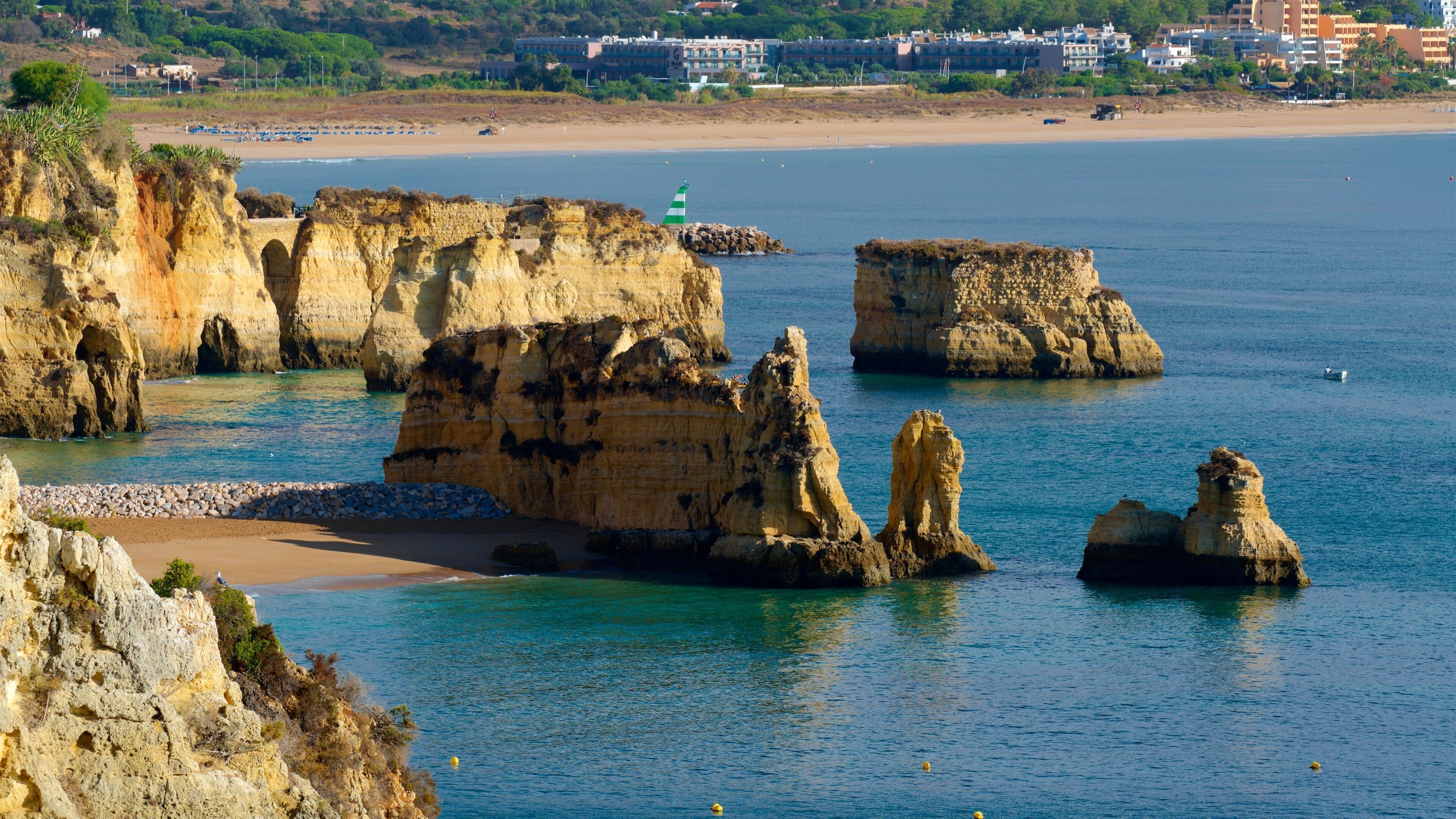 Camilo Beach featuring a sandy beach, general coastal views and rocky coastline