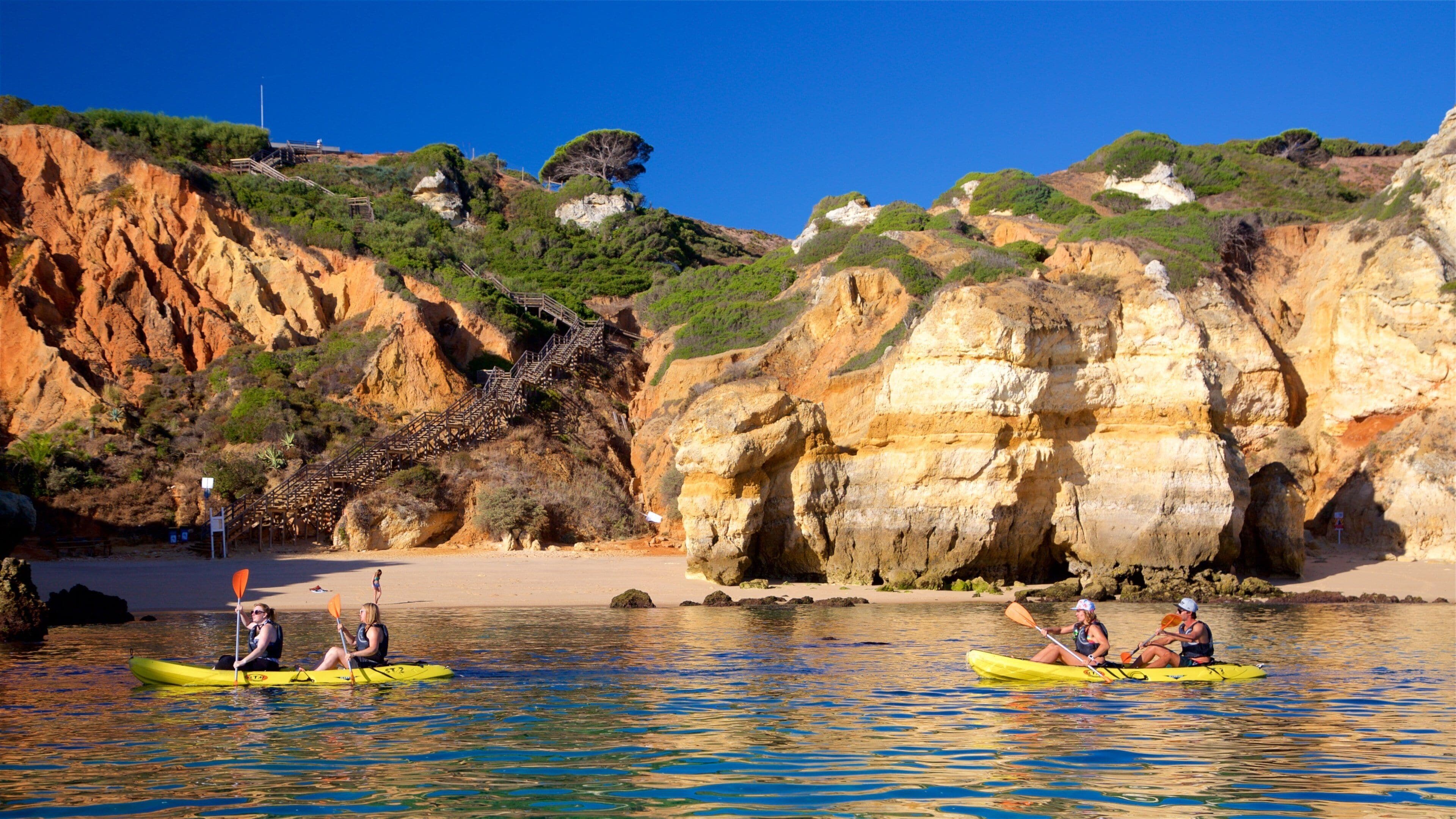 Lagos Lighthouse featuring a sandy beach, rugged coastline and kayaking or canoeing
