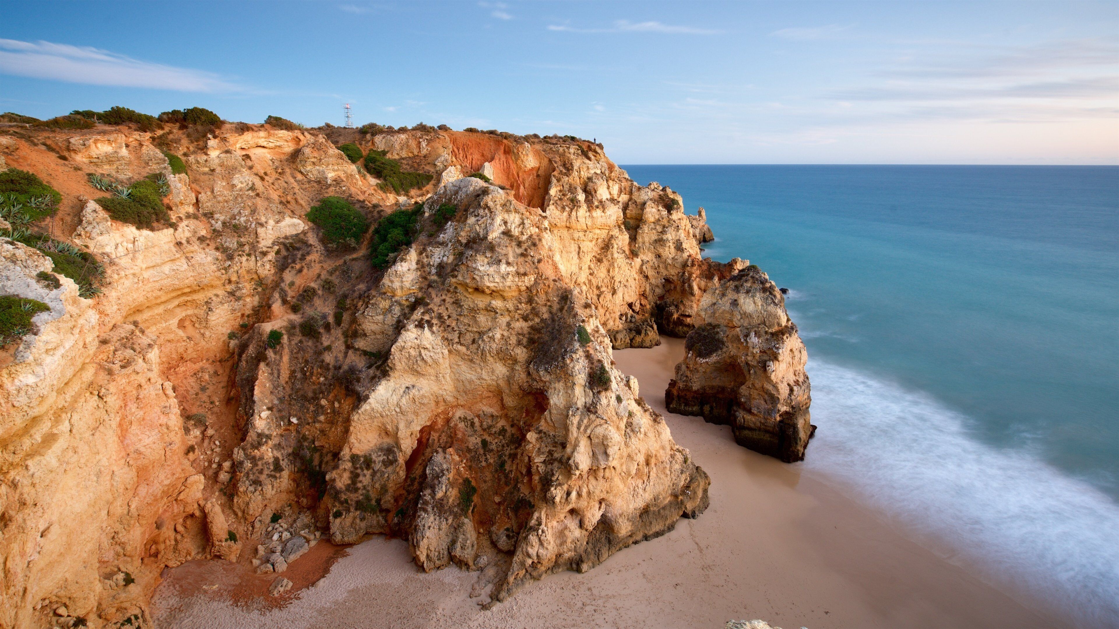 Lagos Lighthouse showing a beach, rugged coastline and general coastal views