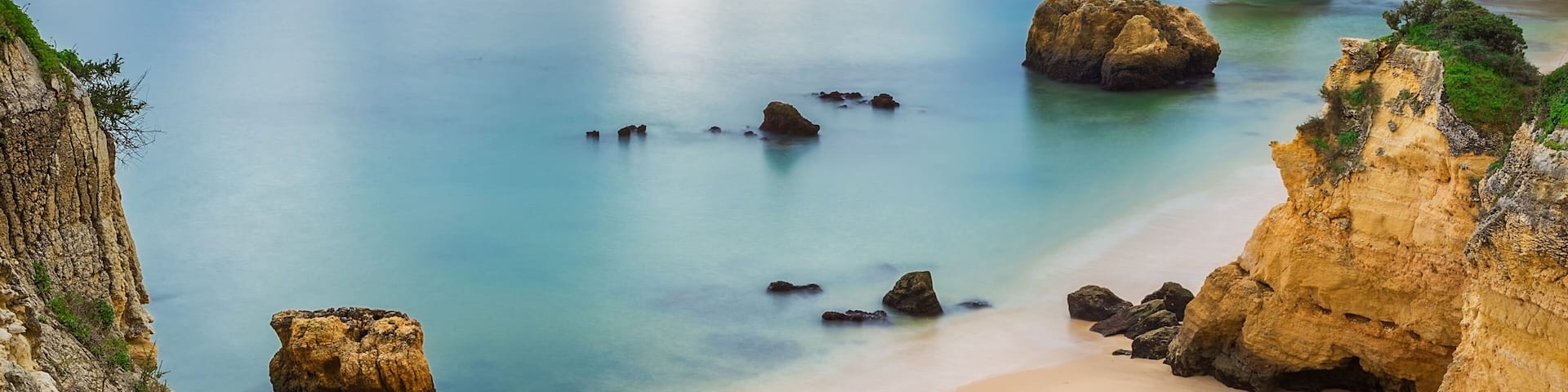 Sea beach at sunset. Cloudy sky. Portugal, Algarve, Lagos.