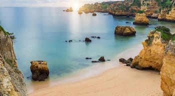 Sea beach at sunset. Cloudy sky. Portugal, Algarve, Lagos.