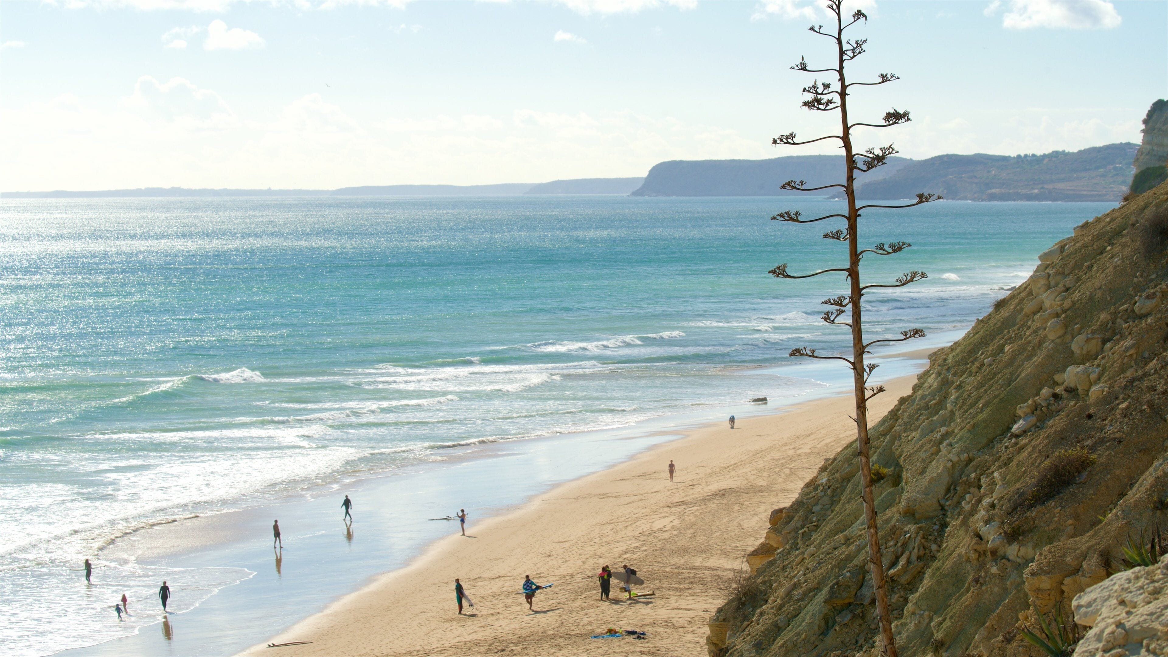 Porto de Mos Beach which includes general coastal views and a beach