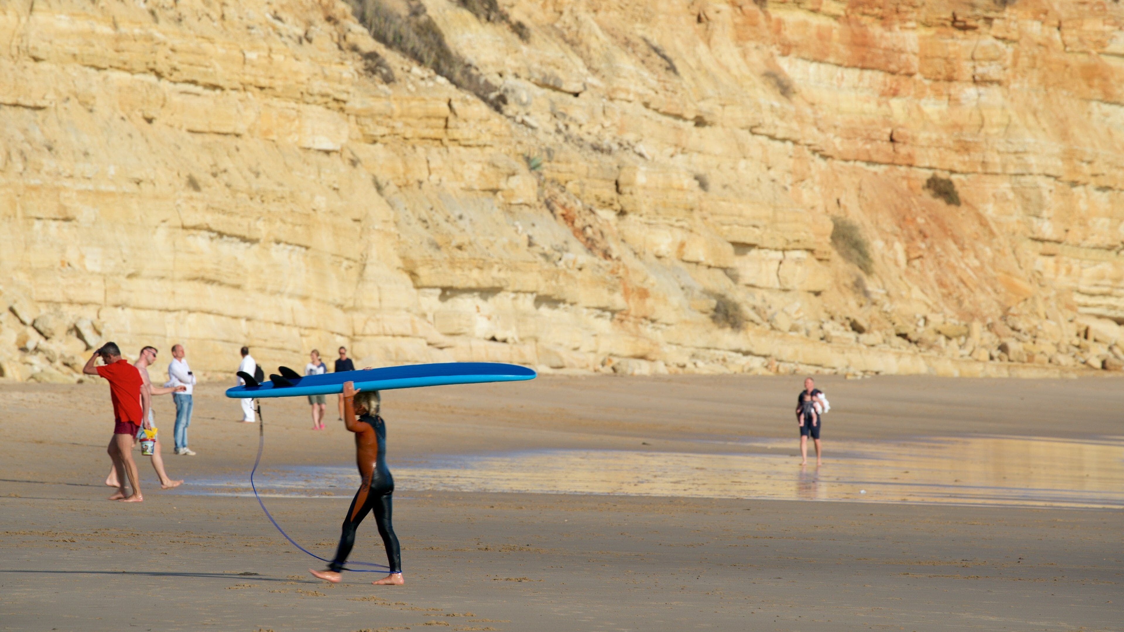 Porto de Mos Beach which includes rugged coastline, a sandy beach and general coastal views