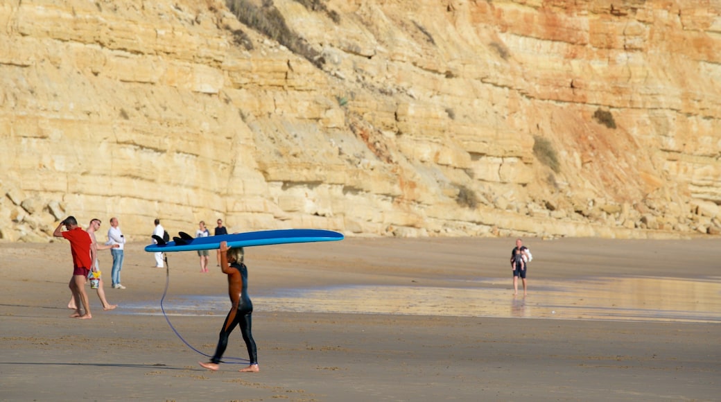 Porto de Mos Beach which includes rugged coastline, a sandy beach and general coastal views