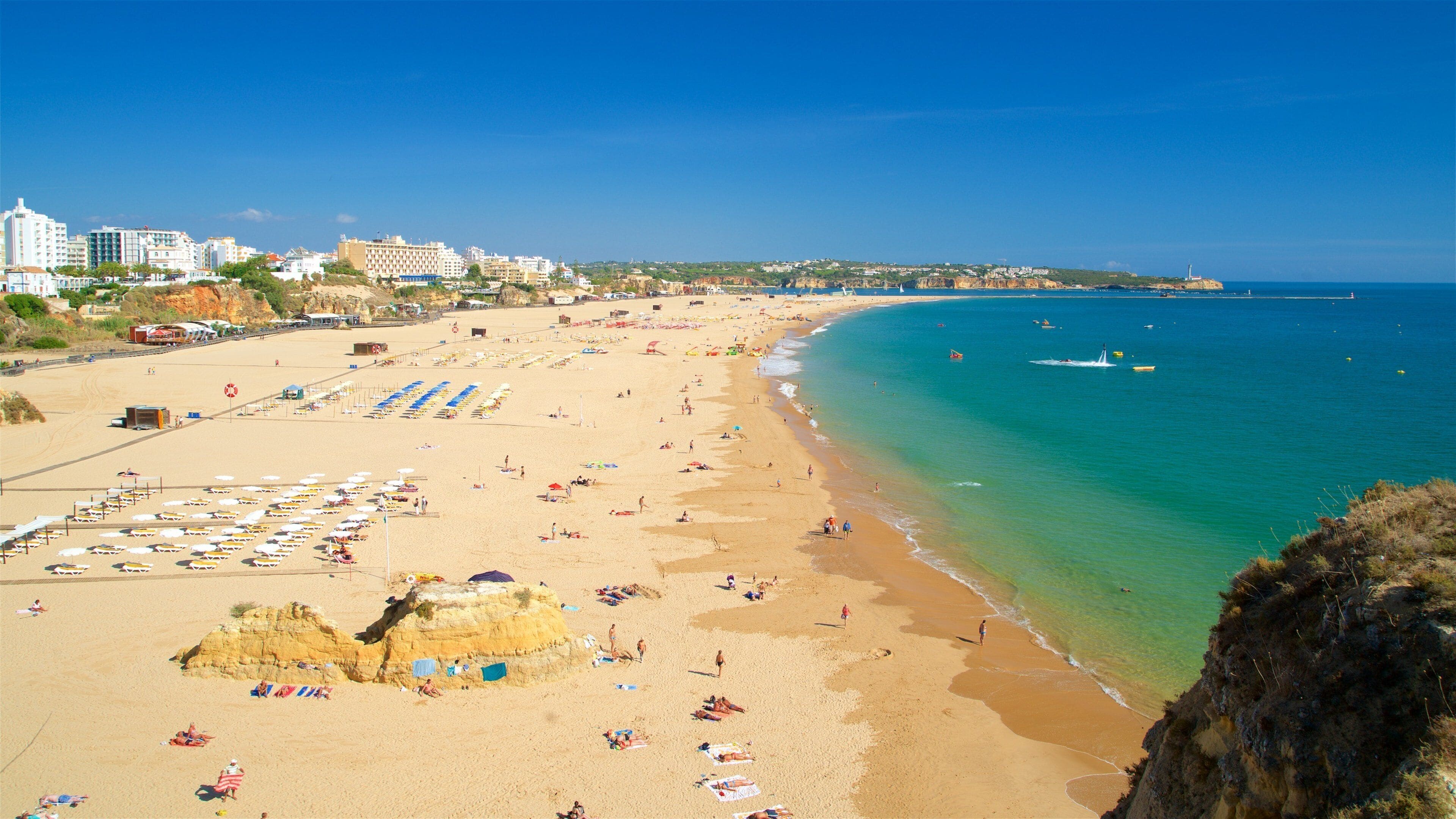 Rocha Beach which includes a sandy beach, a coastal town and general coastal views