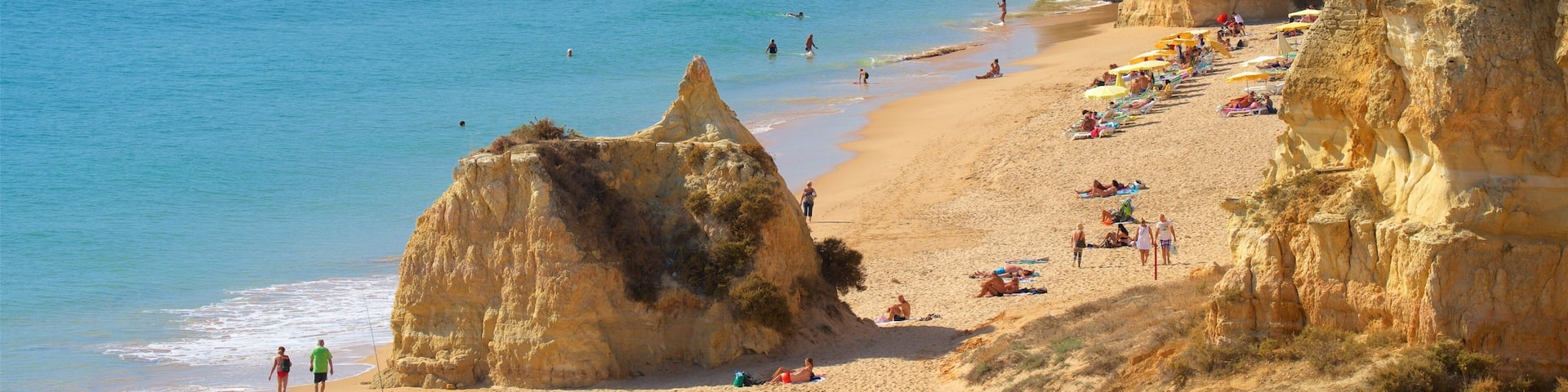 Rocha Beach featuring a sandy beach, general coastal views and rugged coastline