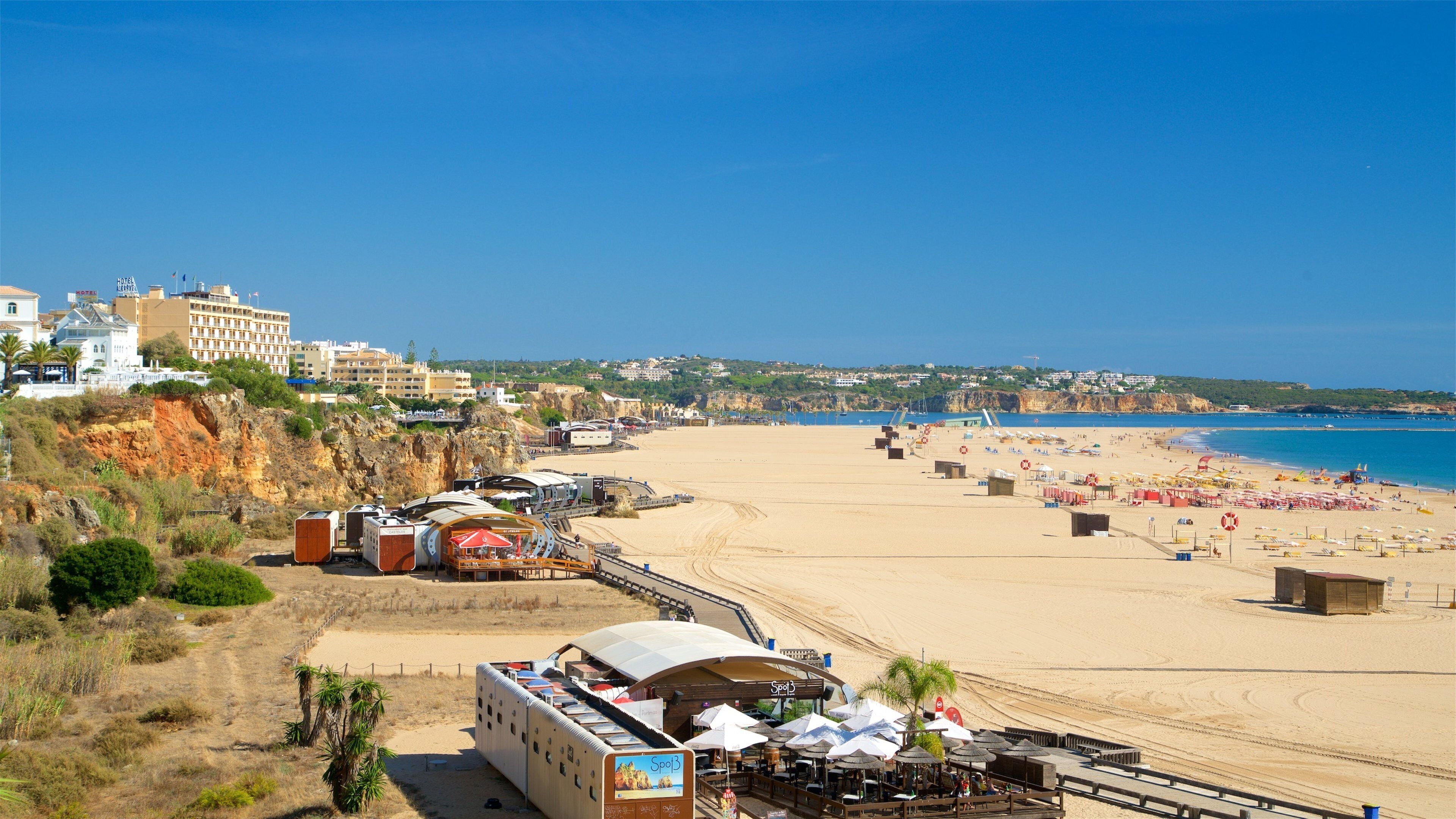 Rocha Beach showing a sandy beach, general coastal views and a coastal town