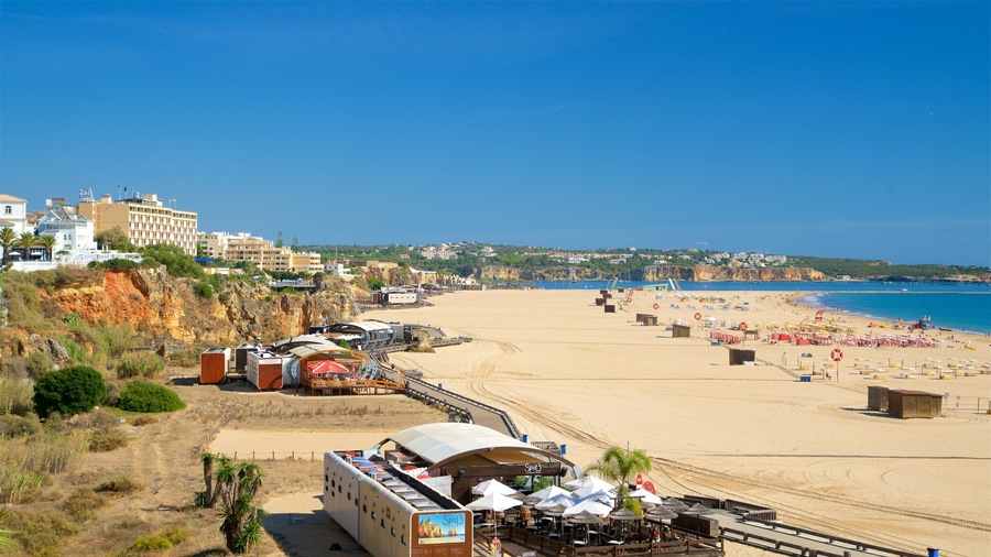 A coastal beach with a sandy shore, umbrellas, and a restaurant named 'Spot 3'.